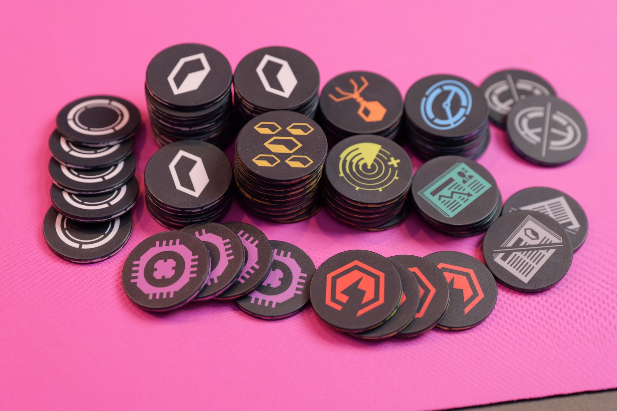 Stacks of ceramic poker chips on a pink playmat