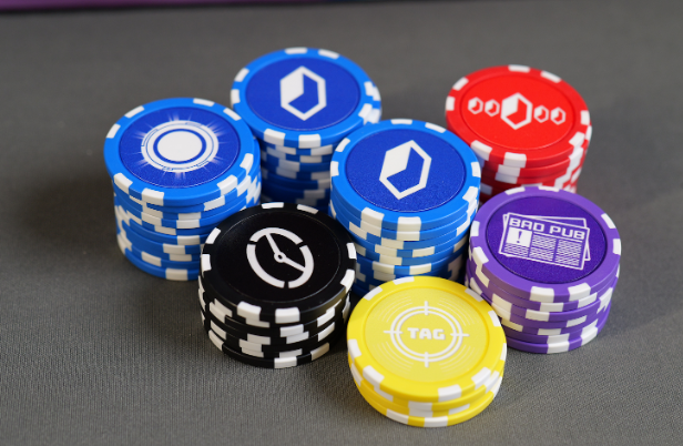 Stacks of composite poker chips on a pink playmat